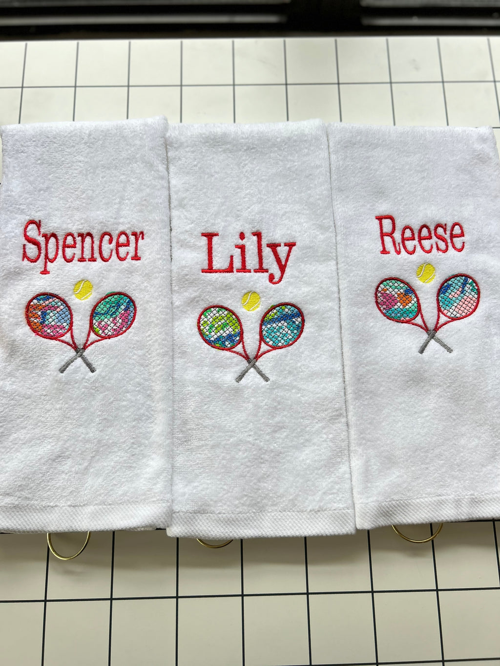 Tennis towel with grommet